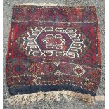 A Persian kelim rug, with a central polychrome hooked medallion, 81 x 76cm.