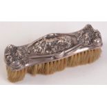 An Edwardian Art Nouveau embossed silver mounted brush.