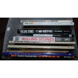 A box of Rolling Stones related books including "The Stones A History In Cartoons" by Bill Wyman.
