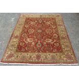 An Indian carpet, the red ground with an all over design of flowering,