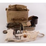 A WWII soldier's personal equipment canvas bag dated 1942, comprising of two mess tins, gloves,