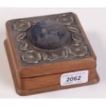 An Edwardian oak jewel box, the pin cushion lid with embossed poppy head silver mount,