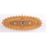 A late Victorian 15ct matte gold oval brooch set a sapphire and two diamonds, Chester 1896.