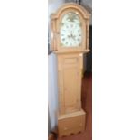 A pine eight day long case clock, the painted dial with a basket of flowers to the arch,