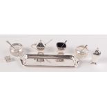 A three section cruet and stand, a pair of open salts with silver mounts and a pill box.