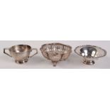 A pierced silver bonbon basket, a silver sweetmeat bowl and an Irish twin handled small silver bowl.