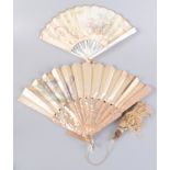 A mother of pearl silk fan, painted decoration of a couple before a statue, in a country scene,