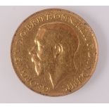 A George V sovereign dated 1928 South Africa mint, nearly very fine.