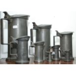 Eight French pewter measures, ranging from 'double litre' to 'centilitre', maker's mark to base,