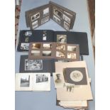 A brass covered photograph album, early 20th century, with European scenes and two similar,