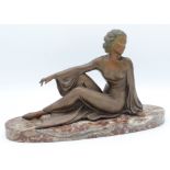 A white metal seated lady on an oval red marble base, height 21cm, length 35cm.
