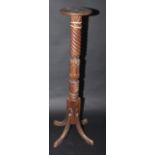 A mahogany torchiere.