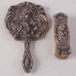 An Art Nouveau silver hand mirror and matching brush.