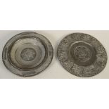 A pewter dish in 17th century style, to the centre Christ holds a flag and cross,