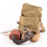 A 1943 gas mask in its original canvas bag, complete with cleaning kit,