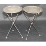 A pair of campaign style folding tripod tables, with 44.5cm diameter tray tops.