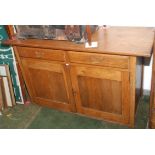 An Arts and Crafts oak sideboard with a pair of doors above a pair of panelled doors, width 138cm.