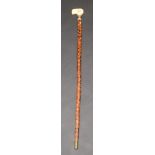 A 19th century Anglo Indian walking stick, the ivory handle above a chased silver collar named J.
