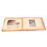 An early 20th century wedding photograph album, including paper cuttings etc, 28 x 38.5cm.