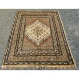 A Turkish carpet, the brown field with an ivory stepped medallion within multiple borders,