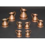 Nine copper bellied measures, ranging from 'pint' to '1/8 gill', largest height 16cm.