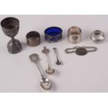 An Indian silver measure, three silver napkin rings, a military identity bracelet etc.