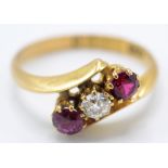 An Edwardian 18ct gold Chester hallmarked ring with a double ruby and diamond crossover.