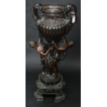 A large reproduction bronze urn, the twin scroll, leaf moulded handles and fluted,