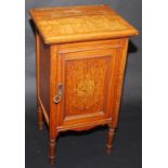 A late Victorian satinwood bedside cabinet, the door with penwork decorated marquetry.