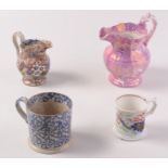 A Sunderland lustre pottery jug, height 19cm, a floral decorated jug and two mugs.