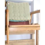 A 1950s Parker Knoll style open armchair.