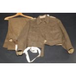A WWII battle dress jacket and trousers, complete with original braces, shoulder pips inscribed R.