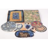 A selection of Chinese silk embroideries and metal thread panels etc.