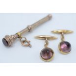 A pair of amethyst cufflinks set in gold,