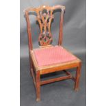 A set of six Chippendale style carved mahogany dining chairs, with ornate splats,