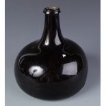 An English globe and shaft glass wine bottle, 17th/18th century, height 15.5cm.