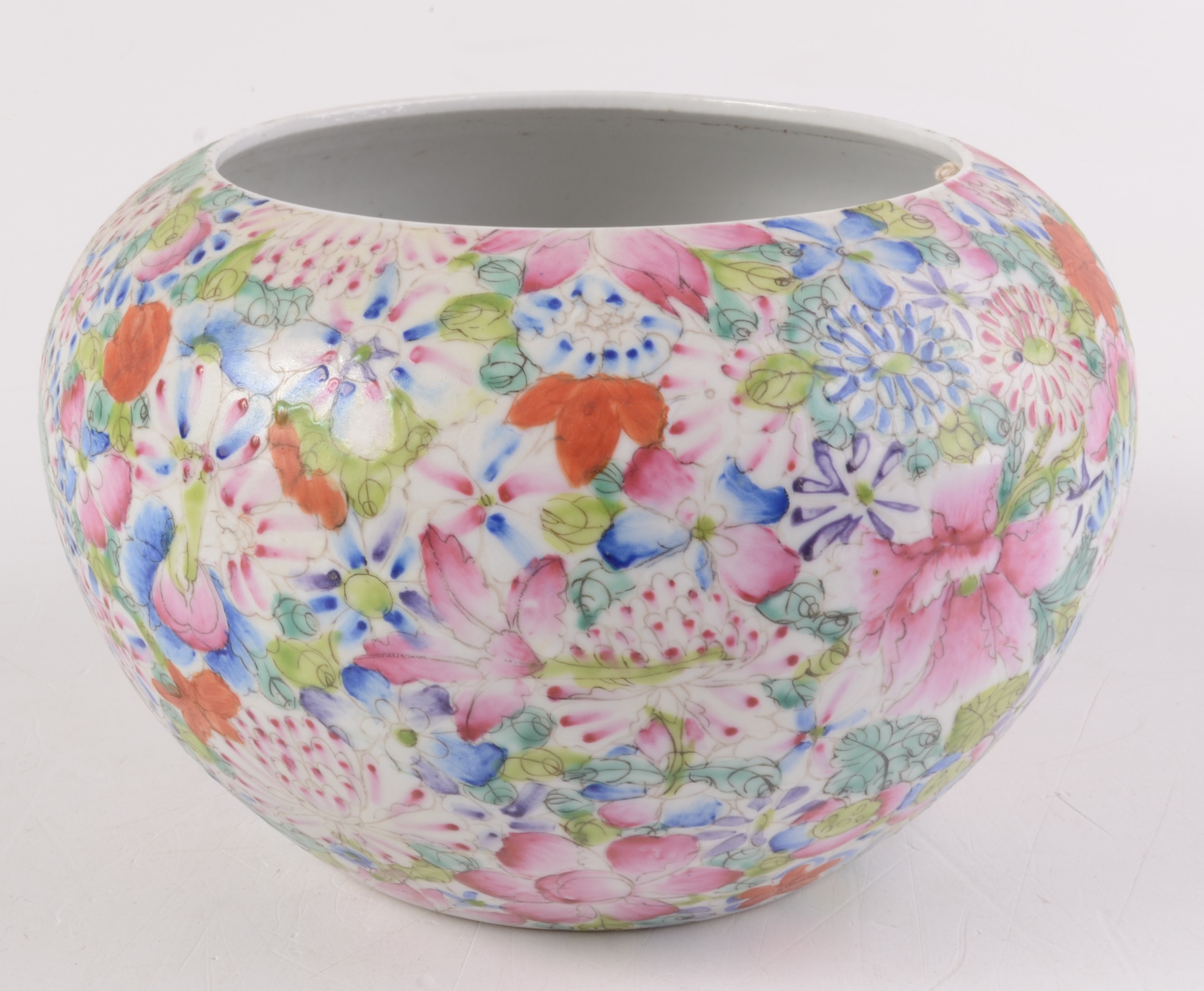 A Chinese porcelain millefiori bowl, densely painted with flowers on a white ground,