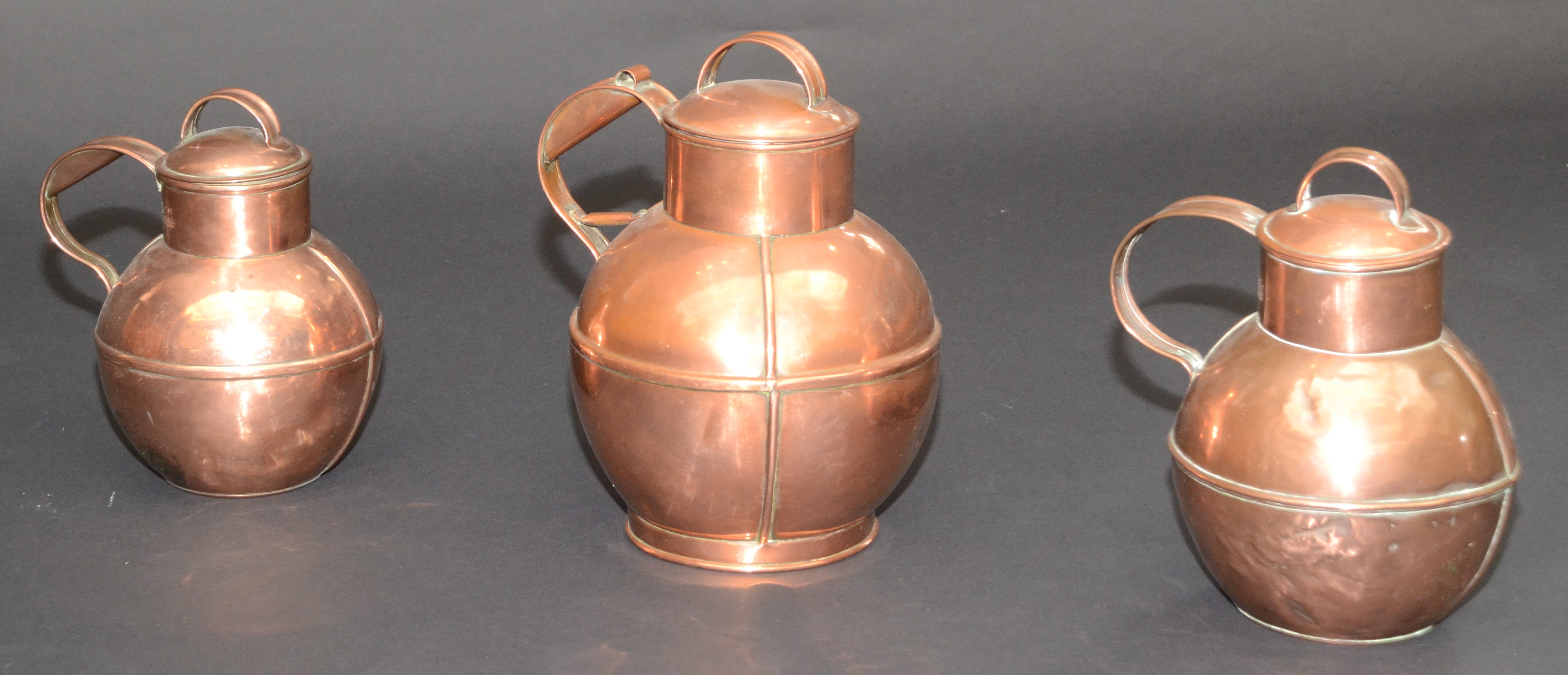 Three Jersey copper graduated jugs and covers, early 20th century, - Image 2 of 2