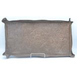 An Arts and Crafts rectangular copper tray, decorated with leafy vines and a central flowerhead,