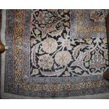 A Kashmir silk carpet, the ivory field with a central lobed pole medallion,