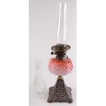 An Edwardian Duplex oil lamp, with pink opaque glass font and cast metal base,