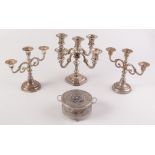 A four branch candelabrum, together with a pair of three nozzle candelabra and one other piece.
