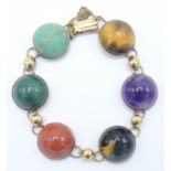 A 9ct gold bracelet set six semi precious stone cabochons.