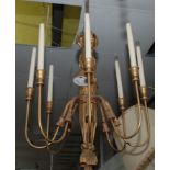 A gilt eight branch chandelier with ribbons and tassels, height 74cm.