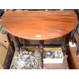 A Victorian mahogany oval Sutherland table with turned supports.