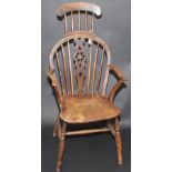 An unusual 19th century wheel and stick back armchair with extended stick head rest.