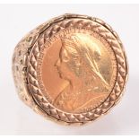 An ornate 9ct gold ring mounted with an old head Victoria half sovereign, 10.2g.