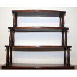 A late Georgian mahogany four tier graduated wall rack with bow front and baluster support,