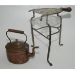 A Georgian brass and iron trivet, height 34cm, together with a copper kettle, 19th century,