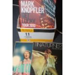 A box of concert programmes including Bill Wyman, Paul McCartney and Mark Knopfler.